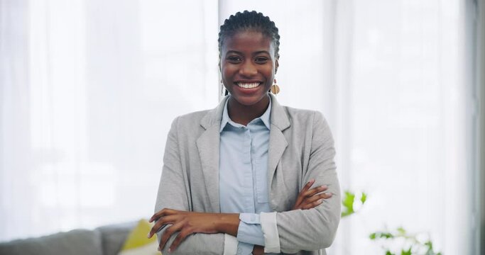 Smile, funny and arms crossed with a black woman in the living room of her home looking happy. Portrait, realtor and confident with a young professional laughing in an apartment for real estate