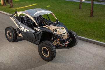 Novosibirsk, Russia - August 29 , 2023: black new Can-Am Maverick ATV, front  view, for off-road driving on a warm summer day