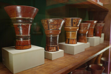 Cusco, Peru - Dec 4, 2022: Ancient Inca Qero vases on display at the Hacienda Huayoccari art collection