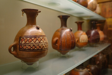 Cusco, Peru - Dec 4, 2022: Ancient Inca Qero vases on display at the Hacienda Huayoccari art collection - obrazy, fototapety, plakaty