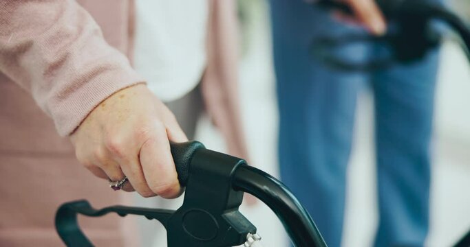 Senior woman, hands and walker in physiotherapy with nurse, therapist or support for patient in nursing home or rehabilitation. Balance, frame or person walking steps with caretaker in physio therapy