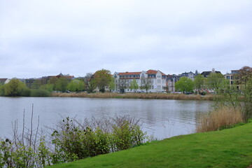Fototapeta na wymiar The Lake Schwerin (German: Schweriner See) at the castle and the city on a cloudy day