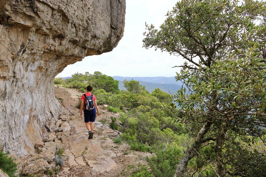 hiking in the the National Park of Barbagia with limestone rocks and green forest hill, mountain. Central Sardinia, Italy, summer day