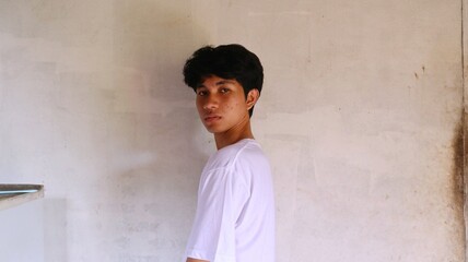 handsome asian man is looking at the camera