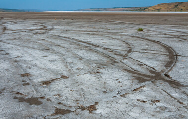 A drying up reservoir, traces of wheels on a dry muddy bottom of the Kuyalnik estuary, Odessa...