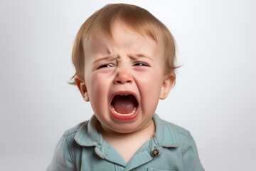 a small child cries and screams with his mouth open