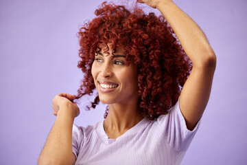 Black woman, hair care and face with smile, natural afro and growth for glow and shine in studio on purple background. Wellness, person and healthy texture of cream and argon oil cosmetics indoor