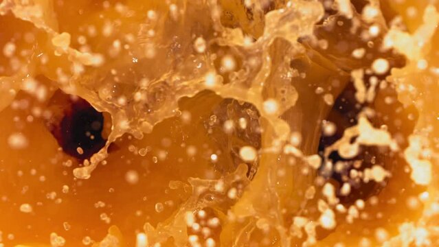 Super Slow Motion Shot of Fresh Peaches Falling into Juice Whirl
