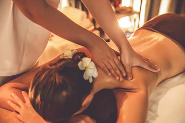 Fotobehang Massagesalon Caucasian woman customer enjoying relaxing anti-stress spa massage and pampering with beauty skin recreation leisure in warm candle lighting ambient salon spa at luxury resort or hotel. Quiescent