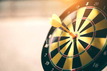 Bullseye target goal or dartboard has dart arrow throw hitting center shooting for financial...
