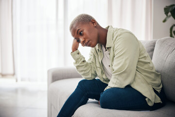 Woman, thinking and anxiety on sofa for sad memory, mental health or depression of debt, crisis or fail. Frustrated, lonely and african person remember trauma of abuse, broken heart or stress at home