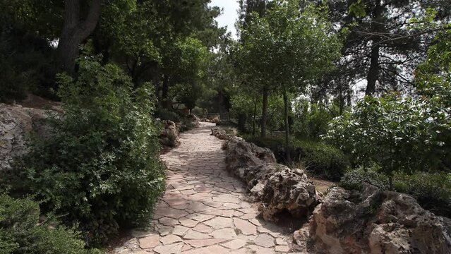 Steady wide shot down stone path in Jerusalem Park