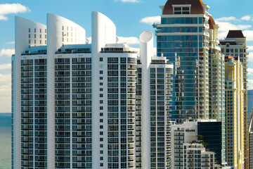 Fototapeta na wymiar Expensive highrise hotels and condos on Atlantic ocean shore in Sunny Isles Beach city. American tourism infrastructure in southern Florida