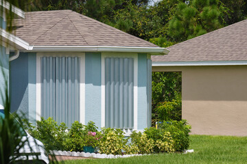 Steel storm shutters for hurricane protection of house windows. Protective measures before natural...