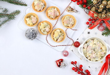 Christmas New Year dishes 2024, traditional holiday olivier salad in a dish and baked baskets with fir branches, cones and decorations, dish design idea, cafe menu, selective focus,