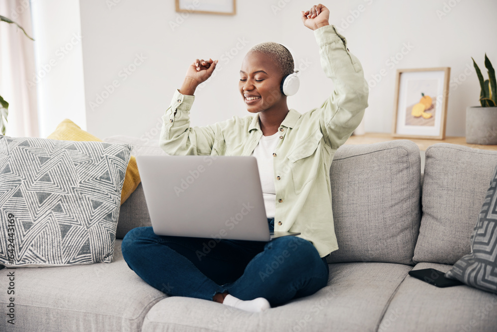 Wall mural Music, dance and black woman with laptop on sofa with headphones, happy and free at home. Radio, earphones and African female dancing to online feel good podcast in living room smile for subscription