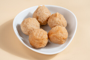 Pempek is a savoury Indonesian fishcake delicacy, made of fish and tapioca from Palembang. Pempek is served with sweet and sour sauce.