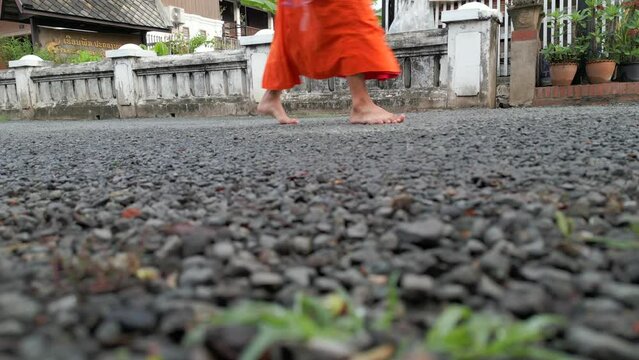 Monks feet close up. Monks strolling through the streets of Luang Prabang during their morning alms collection in Laos. 