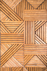 Geometric pattern on the wall of crisscrossing pine slats