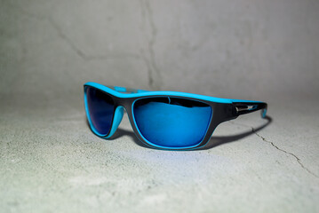 Blue sun glasses isolated over concrete background