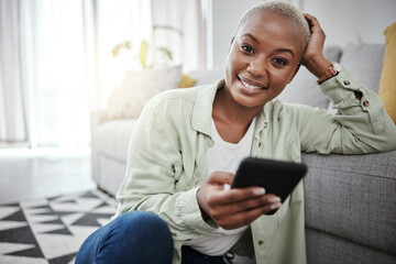 Woman, portrait and typing on smartphone on living room floor for social media post, search contact or download mobile games. Happy african person, cellphone and subscription on digital app at home