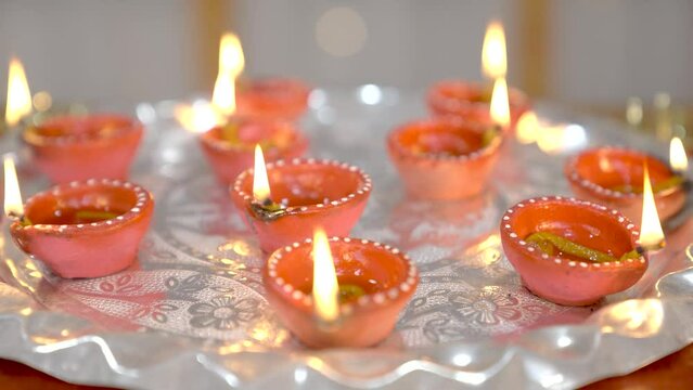 Burning diye for Diwali in thali