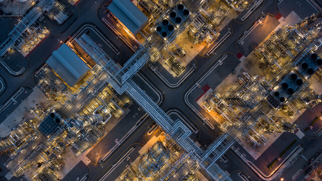 Aerial view power plant for oil refinery petrochemical industrial, Oil  refinery factory power plant at night and pipeline steel, Oil refinery factory and power plant.