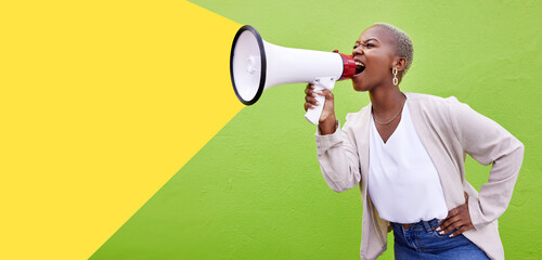 Black woman, megaphone and shouting on mockup space in advertising or marketing against a studio...