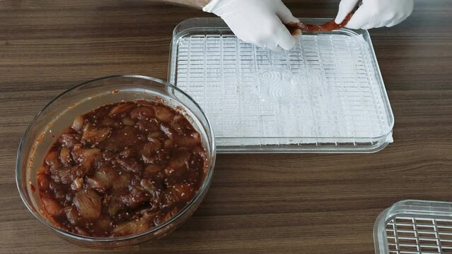 Home cooking Chicken slices while dehydrating making jerky in Dehydrator.