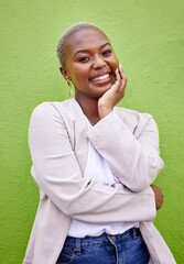Happy, smile and portrait of black woman by a green wall with classy and elegant jewelry and...
