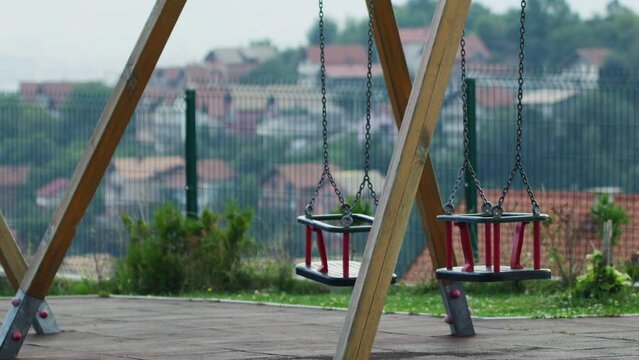 Two Empty Swings Sway in the Breeze