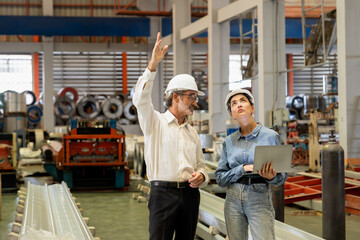 Factory manager or executive make visit metalwork manufacturing factory tour and inspect heavy...