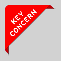 Red color of corner label banner with word key concern on gray background