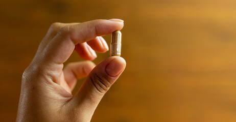 Herbal tablet held in hand, herbal product to improve health, natural medicine, drug dosage