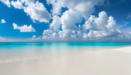 Obraz premium Sandy beach with white sand and rolling calm wave of turquoise ocean on sunny day, white clouds in blue sky background