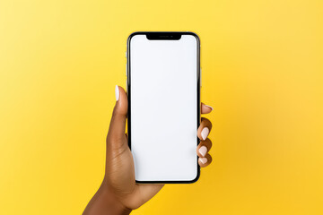 Woman holding up blank smartphone phone screen under yellow
