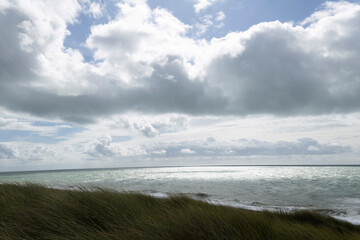 Beach cabins and seashore in Gouville sur Mer, Manche, Normandy, France in various lights