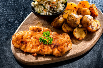 Chicken cutlet coated with breadcrumbs with potatoes and cabbage