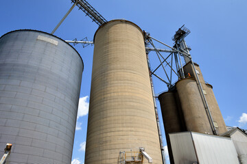 Variety of grain elevators at an agricultural cooperative in an Illinois community.. Cooperatives such as this remain typical of those found throughout the Midwestern United States.