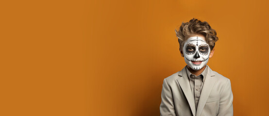 Banner of happy cheerful smiling teenage boy with skeleton face paint celebrates Halloween. October 31 celebration concept. Empty space place for text, copy paste, horizontal orange studio background