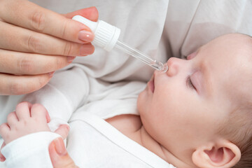 Newborn gets nasal care while sleeping, Concept of mother's loving attention