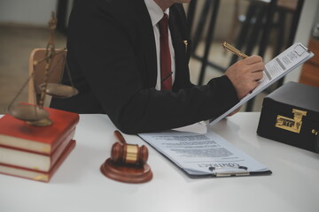 Business and lawyers discussing contract papers with brass scale on desk in office. Law, legal...