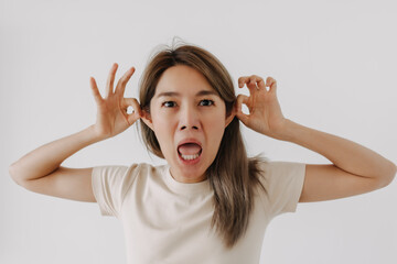 Asian man make funny teasing face for humor isolated on white.