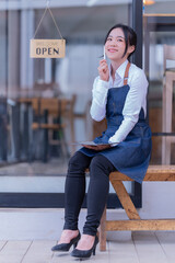 Portrait of Asian woman barista cafe owner. SME entrepreneur seller business concept