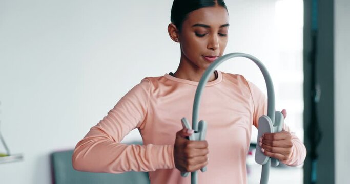Wellness, woman and pilates ring for workout and exercise in fitness studio with focus and mindset. Training, gym and person with healthy body for lifestyle, balance and strong muscle in sportswear