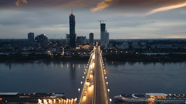 Vienna night skyline aerial view drone footage of city vienna asutria fly over brdige in fron vienna skyscrapers.
