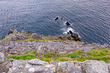 Waves crashing on rocks around the islands in Atlantic ocean