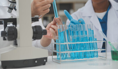 Scientist or medical in lab coat working in biotechnological laboratory, Microscope equipment for...