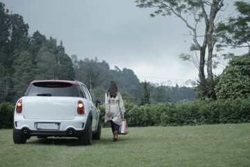 car and woman in the mountains