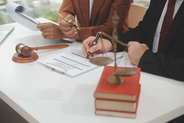 Business and lawyers discussing contract papers with brass scale on desk in office. Law, legal...